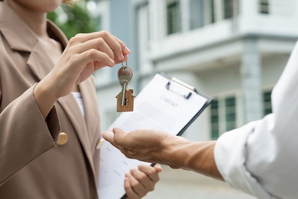 lease, rental and selling home. Real estate agent manager smile holding key for new owner. rent house, Sales, loan credit financial, insurance, Seller, dealer, installment,  buy, sell, move in