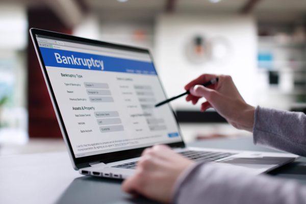 Woman Lawyer Filling Bankruptcy Form on Laptop, Insolvency Notice Online